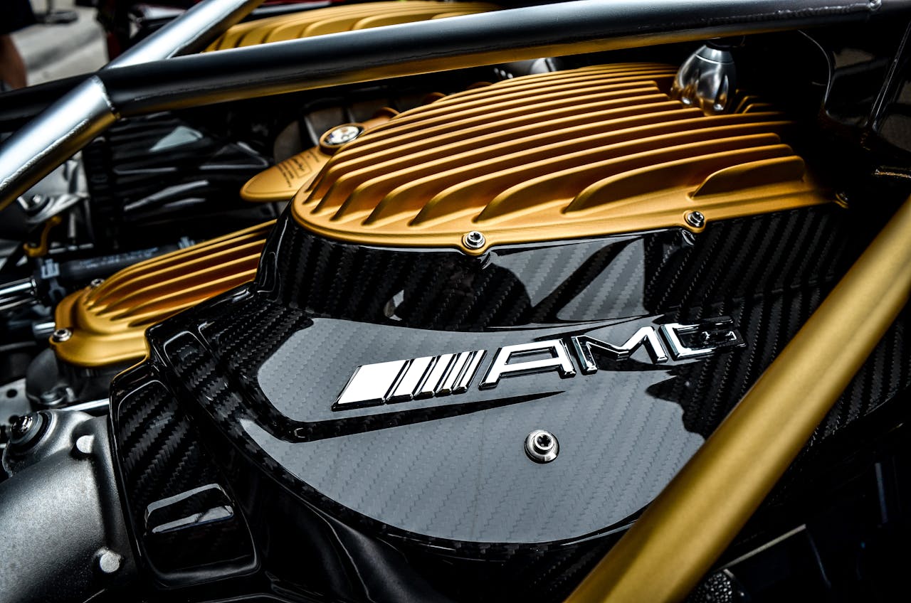 Close-up of a luxury cars engine featuring carbon fiber and gold accents, showcasing high-end design.